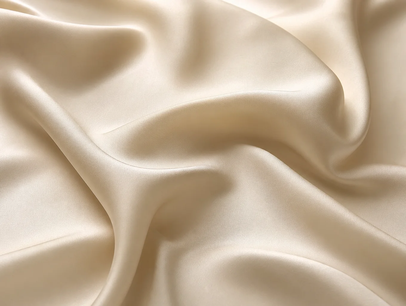 Fluid drape of pure Mulberry silk charmeuse fabric in warm light